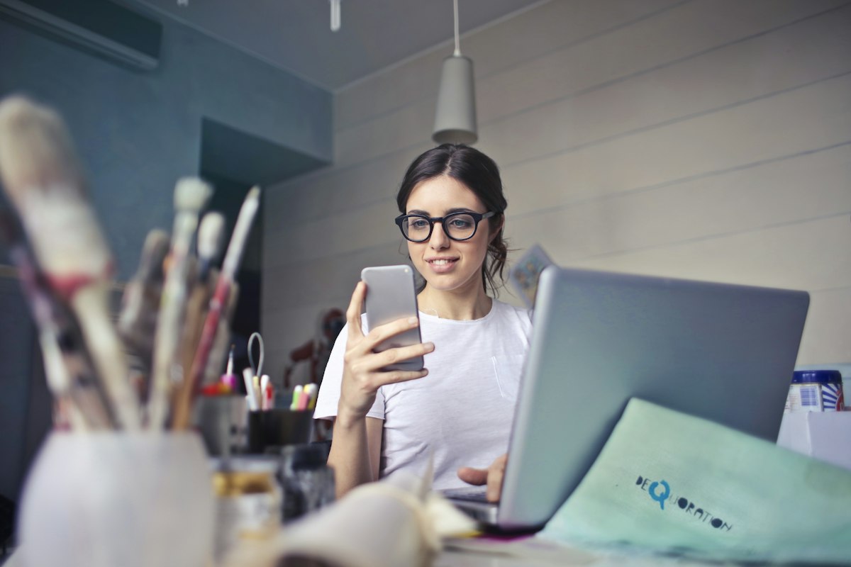 Mulher usando smartphone nas redes sociais, tema do que o advogado não pode postar